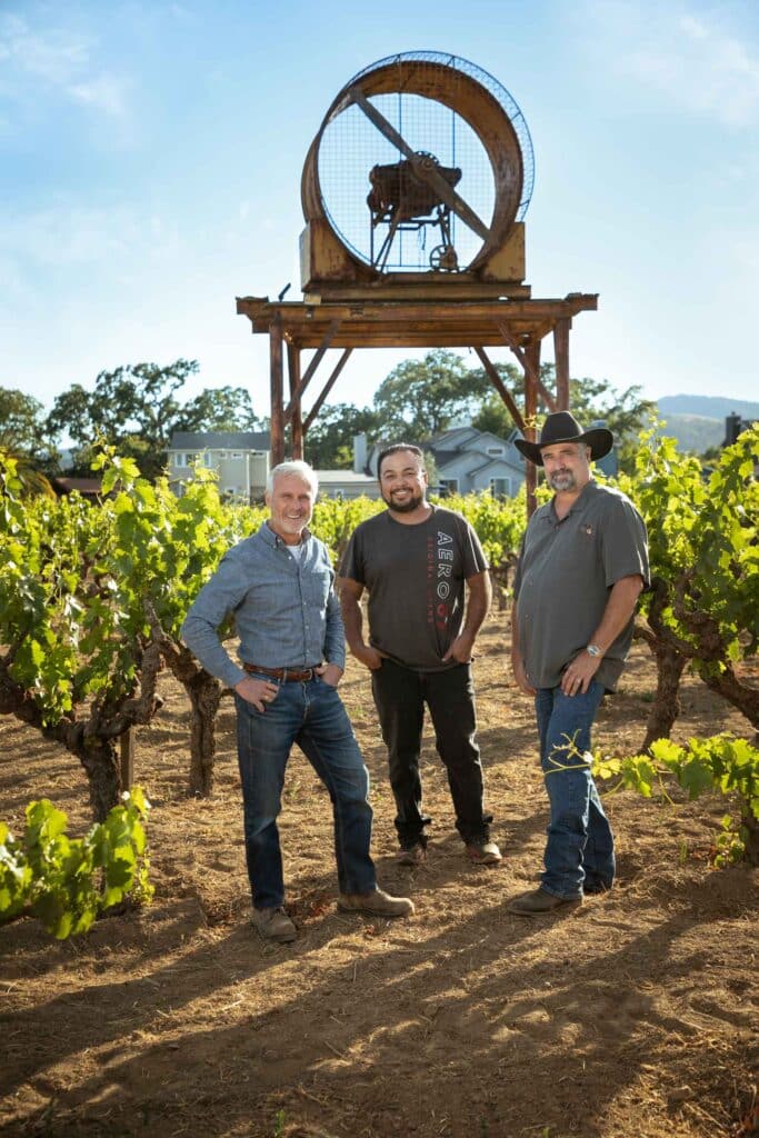 Bob Biale, Raul Ramirez and Mark Biale standing in the Home Ranch Vineyard