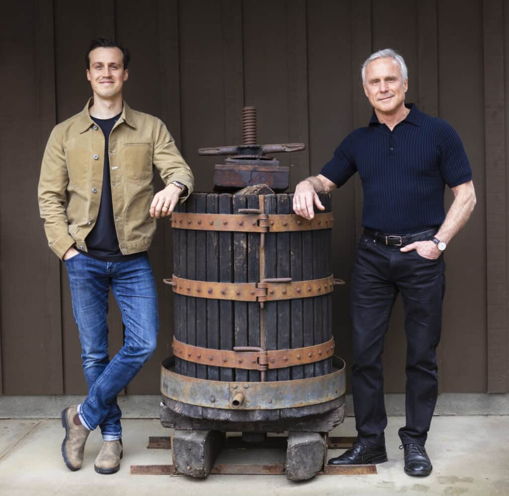 Alex and Bob Biale on either side of an old wine press